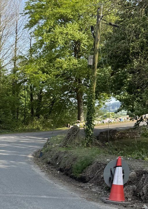 Left: earth and stone hard against the sealed edge. Right: the cut face, open to rain. 1 May 2025. No cones in these frames.